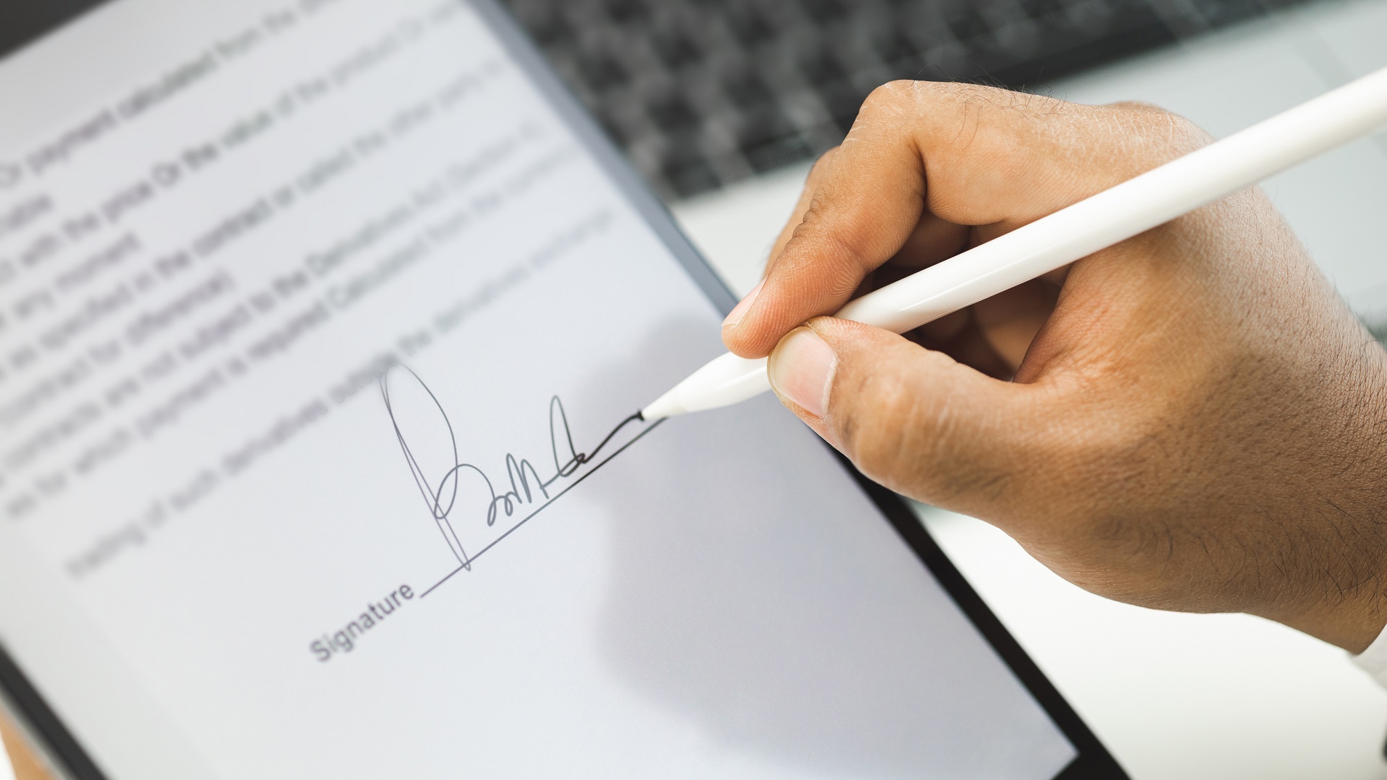 Consumer signing a solar contract on a digital tablet
